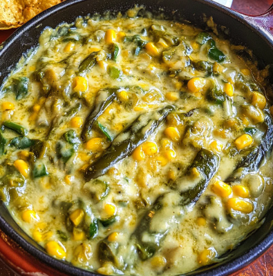 Creamy Rajas con Crema made with roasted poblano peppers, onions, and rich cream sauce served in a bowl.