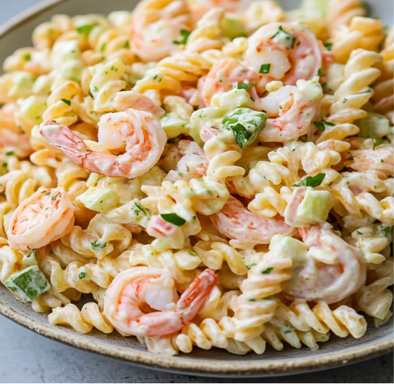 A bowl of creamy shrimp pasta salad made with tender shrimp, macaroni, fresh vegetables, and a homemade dressing