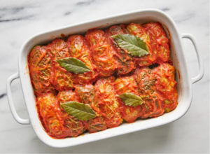 Homemade stuffed cabbage rolls filled with seasoned meat and rice, baked in rich tomato sauce and served warm.