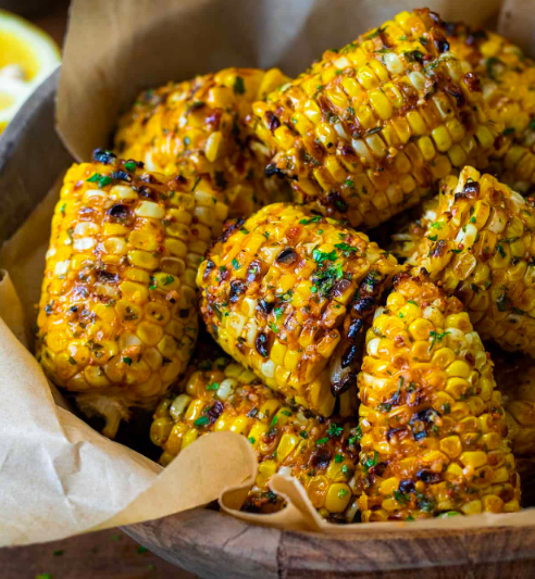 Freshly roasted corn topped with lemon, salt, and chilli powder, served as a delicious monsoon special snack.